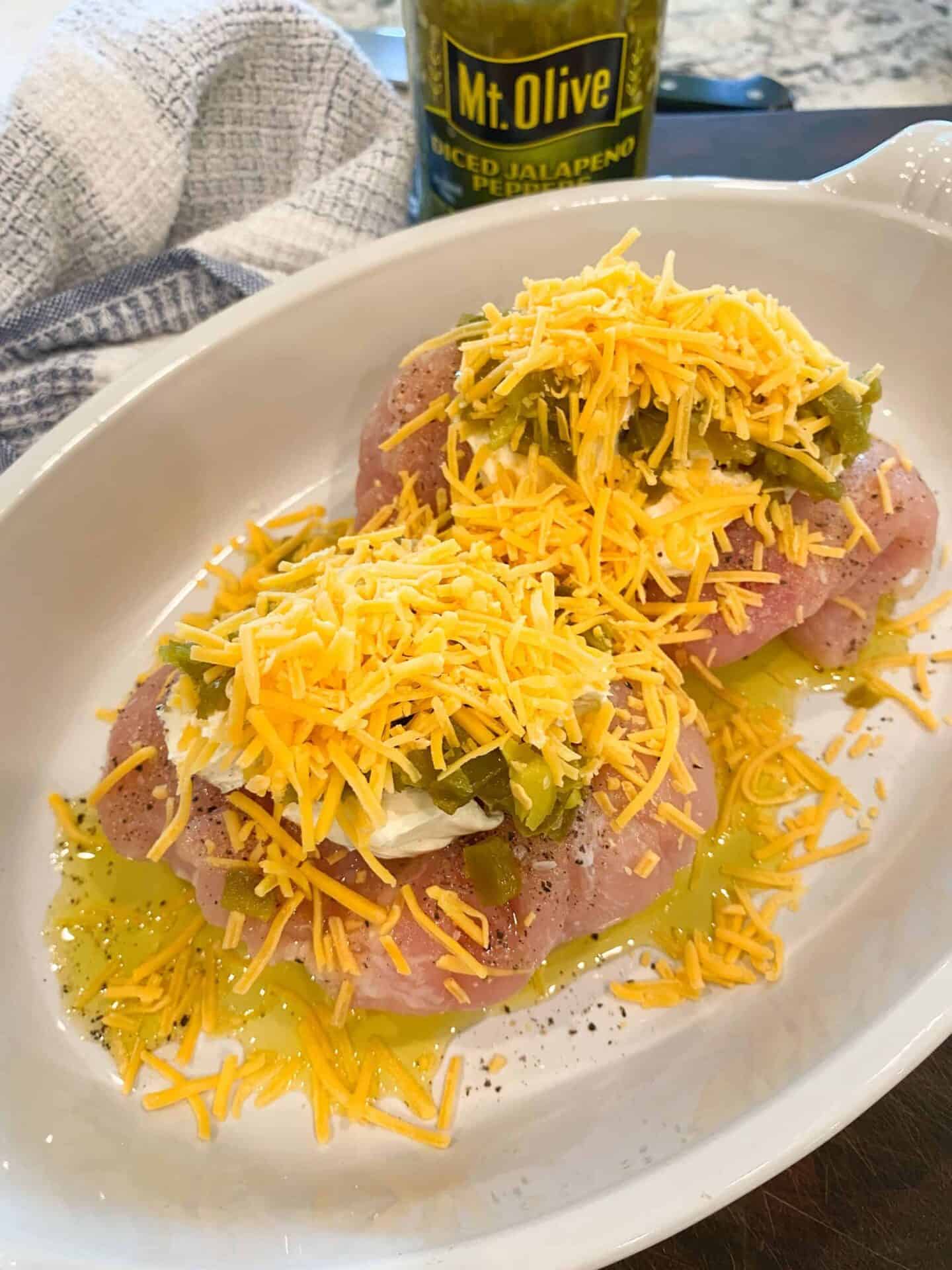 place-shredded-cheddar-cheese-on-top-of-jalapenos