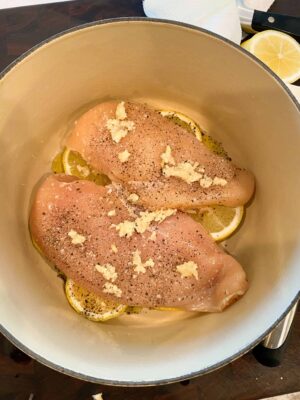 garlic-on-top-of-seasoned-chicken-breasts